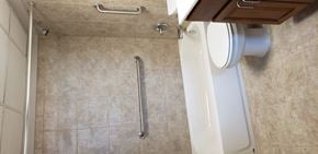 Jellico apartment for rent - a white toilet in a bathroom with a rail next to it