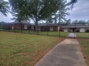 Memphis apartment for rent - a yard in front of a house with a black fence