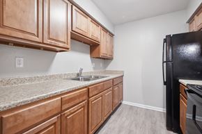 Little Rock apartment for rent - A Kitchen With Black Refrigerator at Fair Oaks Apartments, Little Rock, AR