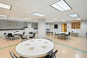 Jackson apartment for rent - A conference room with tables and chairs and a white table in the center.