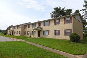 Union City apartment for rent - an apartment building with a green lawn and a sidewalk