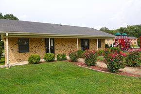 Union City apartment for rent - a house with a yard and flowers in front of it