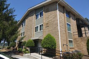 Cleveland apartment for rent - an apartment building with a brick facade and a balcony