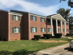 Horse Cave apartment for rent - a brick building with white columns in front of it