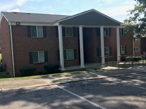 Horse Cave apartment for rent - a brick building with white pillars in front of it