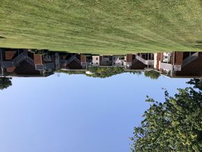 Franklin apartment for rent - A reflection of houses and trees can be seen in a body of water.