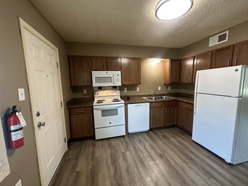 Memphis apartment for rent - A kitchen with a white refrigerator, white oven, and white dishwasher.