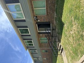 Memphis apartment for rent - Apartment building with green siding and a blue sky above.