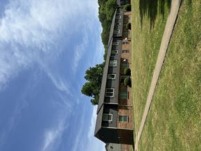 Memphis apartment for rent - A building with a green lawn in front of it.