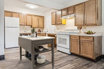 Memphis apartment for rent - A kitchen with wooden cabinets and a white fridge.