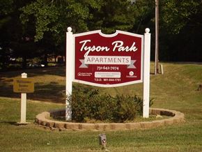 Paris apartment for rent - a sign for tyson park apartments in the grass
