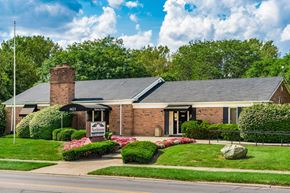 Columbus apartment for rent - Brick rental office with flagpole and flower gardens at Northtowne Apartments, Columbus, OH