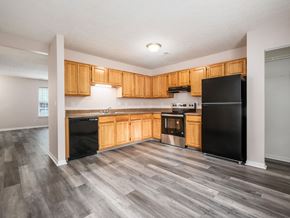 Reynoldsburg apartment for rent - A kitchen with black appliances and wooden cabinets.