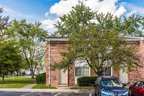 Columbus apartment for rent - Brick townhome exterior with parking and mature trees at Northtowne Apartments, Columbus, 43229