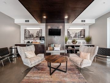 Columbus apartment for rent - A living room with a wooden coffee table and two chairs.
