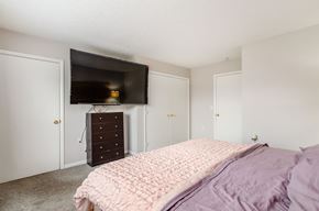 Hilliard apartment for rent - A bedroom with a bed, dresser, and television.