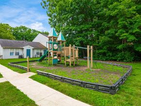 Reynoldsburg apartment for rent - A playground with a green slide and a wooden structure.