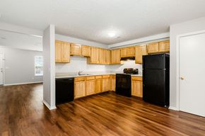 Hilliard apartment for rent - A kitchen with wooden cabinets and black appliances.