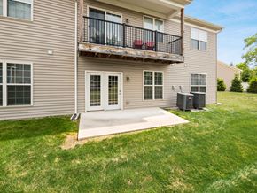 Columbus apartment for rent - A two-story apartment building with a balcony and a driveway. at River View at Bexley Apartments, River View at Bexley, OH, 43209