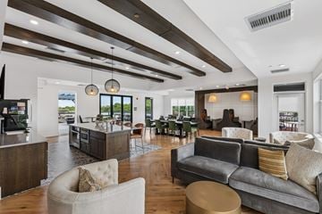 Cincinnati apartment for rent - A modern living room with a grey couch and a wooden ceiling.