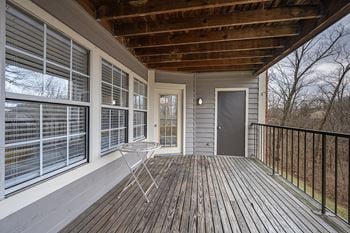 A balcony with a door and a chair on it