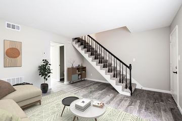 Louisville apartment for rent - a living room with a staircase and a couch and a coffee table
