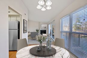 Cincinnati apartment for rent - a dining room with a round table with four chairs and a fireplace in the background at Harpers Point Apartments, Cincinnati, OH