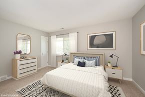 Indianapolis apartment for rent - a bedroom with a large bed and a dresser with a mirror on it at 7 Pointe Apartments, Indiana