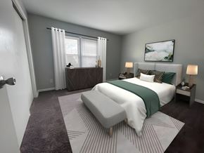Oregon townhouse for rent - a bedroom with gray walls and a white bed with a green blanket