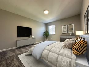 Toledo townhouse for rent - a master bedroom with a large bed and a tv