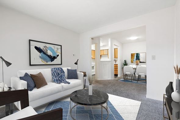 Crawfordsville apartment for rent - A living room with a white couch and a blue and white rug.