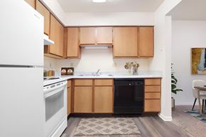 Crawfordsville apartment for rent - A kitchen with wooden cabinets and a white refrigerator.