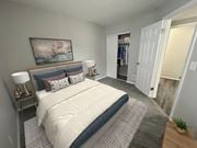 Toledo apartment for rent - A bedroom with a large bed and a painting on the wall.