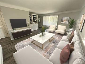 Toledo apartment for rent - A living room with a white couch and a coffee table in the center.
