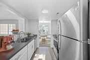 Cincinnati apartment for rent - A modern kitchen with a large refrigerator and stainless steel appliances.
