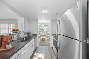 Cincinnati apartment for rent - A modern kitchen with a large refrigerator and stainless steel appliances.