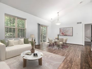 Columbus apartment for rent - A living room with a white sofa, a coffee table, and a painting on the wall.