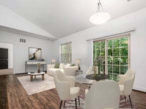 Columbus apartment for rent - A modern dining room with a glass table and white chairs. at River View at Bexley Apartments, River View at Bexley, Ohio