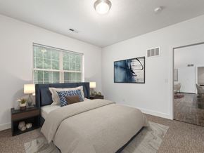 Columbus apartment for rent - A bedroom with a large bed and a painting on the wall. at River View at Bexley Apartments, River View at Bexley, OH