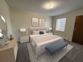 Bowling Green apartment for rent - A bedroom with a large bed and a blue ottoman.