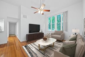 Dayton apartment for rent - A living room with a white ceiling fan and a white coffee table.