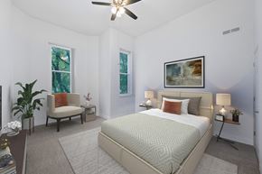 Dayton apartment for rent - A bedroom with a large bed and a ceiling fan.