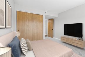 Findlay apartment for rent - A bedroom with a bed, a couch, and a television.