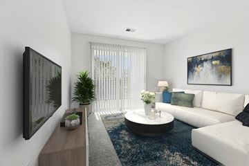 Findlay apartment for rent - A modern living room with a white couch, a coffee table, and a painting on the wall.
