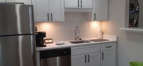 Cincinnati apartment for rent - A kitchen with white cabinets and a stainless steel refrigerator.