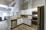 Cincinnati townhouse for rent - a kitchen with stainless steel appliances and white cabinets at The Lofts at Shillito Place, Cincinnati, Ohio
