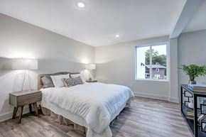 Cincinnati apartment for rent - the master bedroom has a large bed and a large window