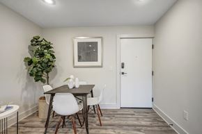 Cincinnati apartment for rent - a dining room with a table and chairs and a white door