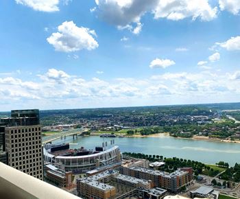 A cityscape with a river and a bridge in the distance.