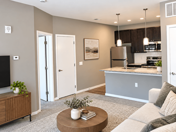Liberty Township apartment for rent - A modern living room with a grey couch and a wooden coffee table.